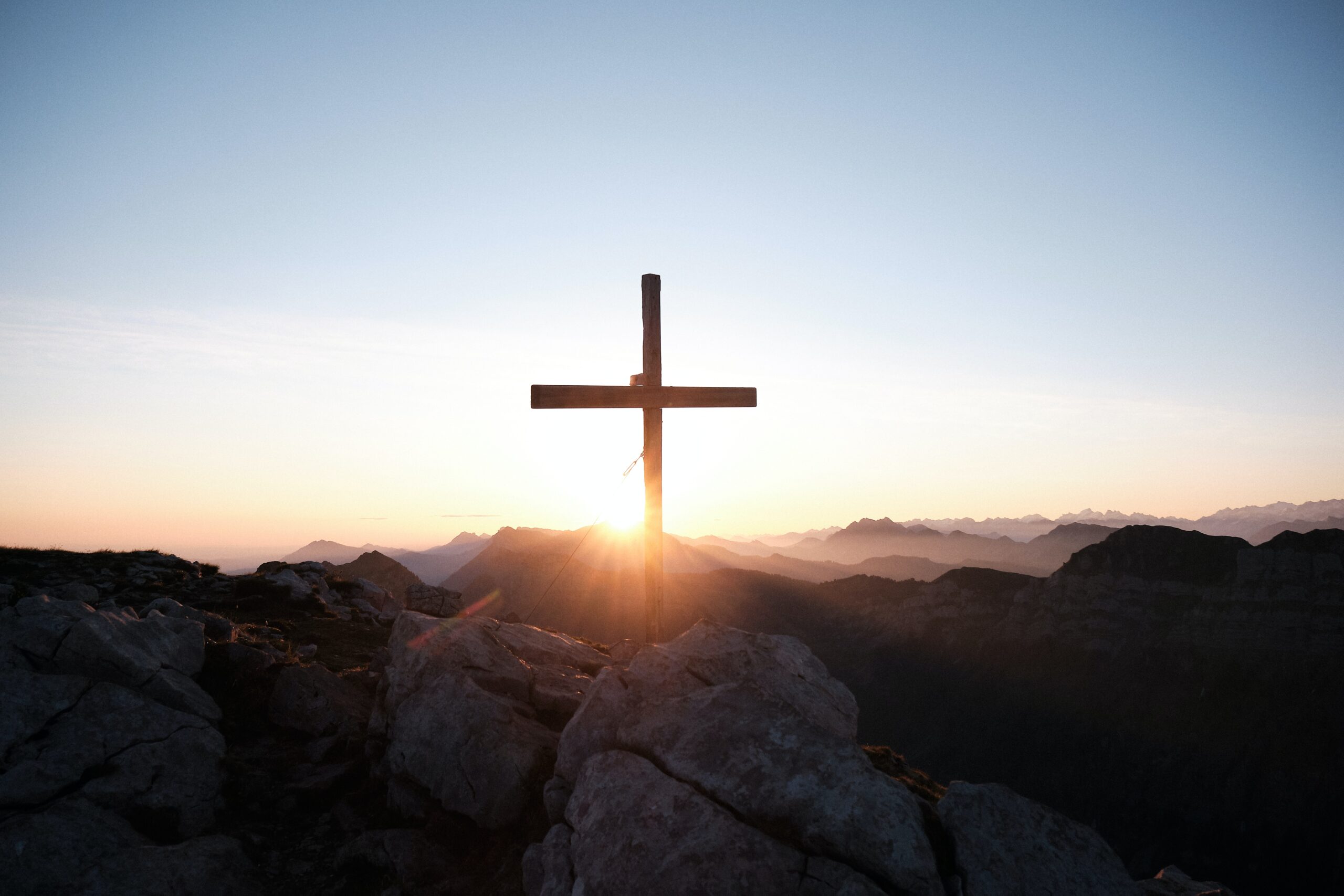 cross with mountains